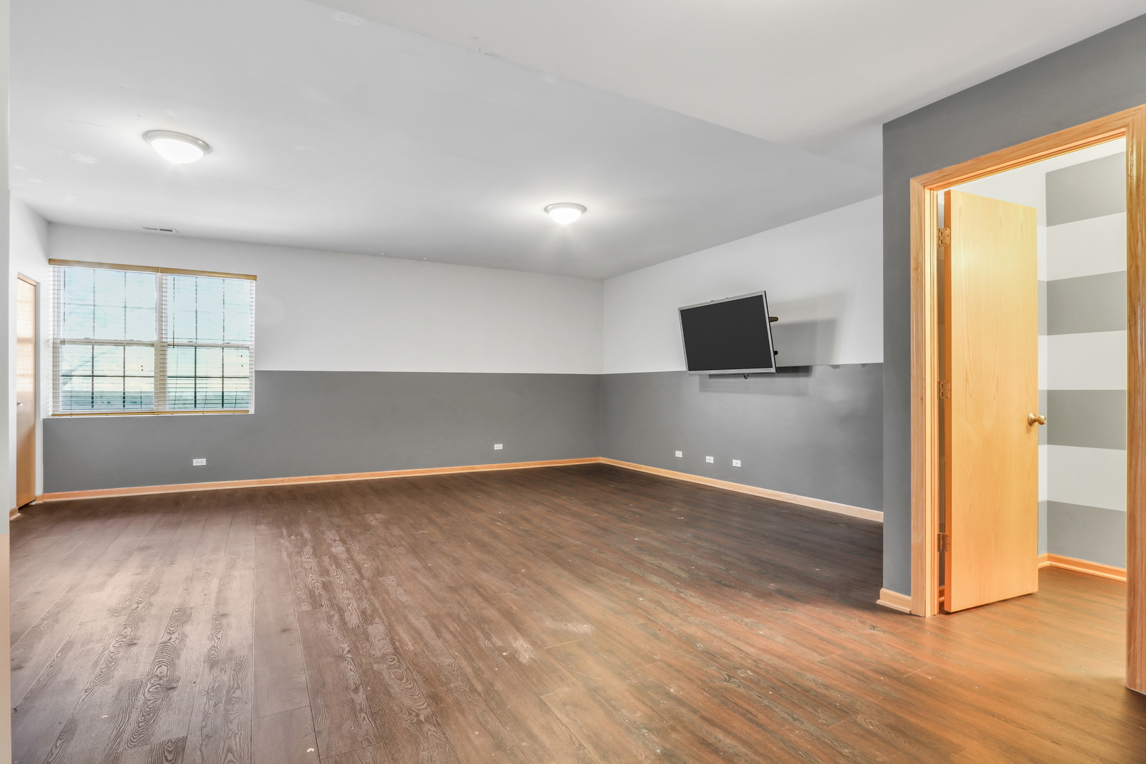 1491 Sedgewood Court Round Lake, IL 60073 - Photo 21 of 31 an empty room with wooden floor and windows