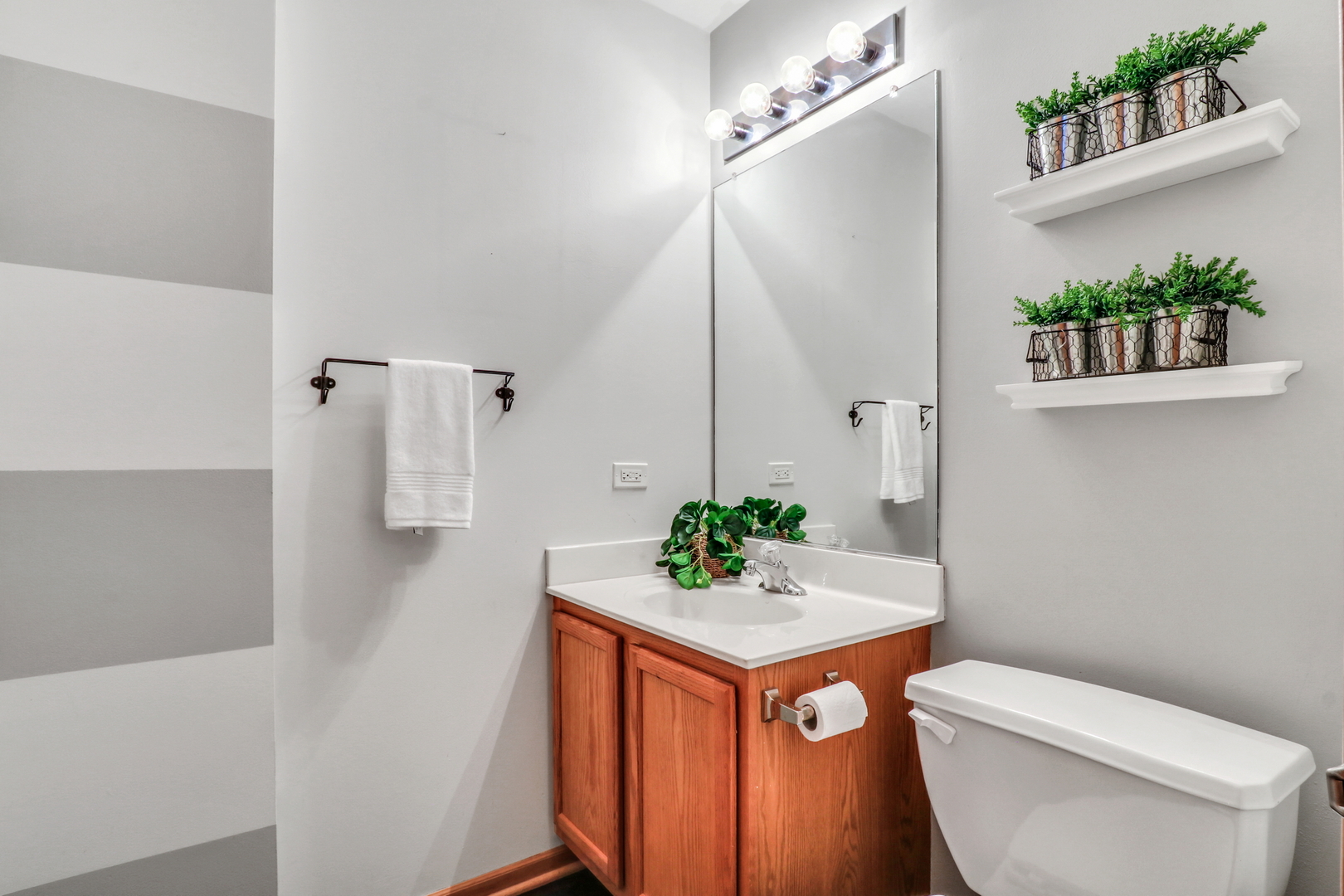 1491 Sedgewood Court Round Lake, IL 60073 - Photo 25 of 31 a bathroom with a sink a toilet and a mirror