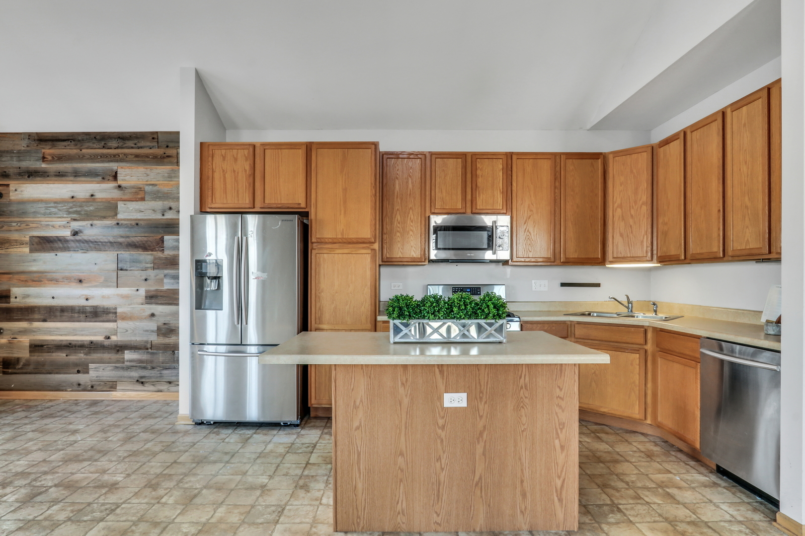 1491 Sedgewood Court Round Lake, IL 60073 - Photo 9 of 31 a kitchen with stainless steel appliances granite countertop a refrigerator sink and microwave