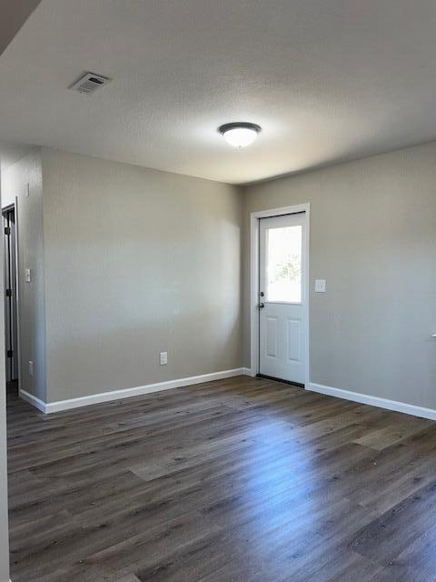 332 Cannon Drive Laurel Hill, FL 32567 - Photo 11 of 36 a view of an empty room with wooden floor and window