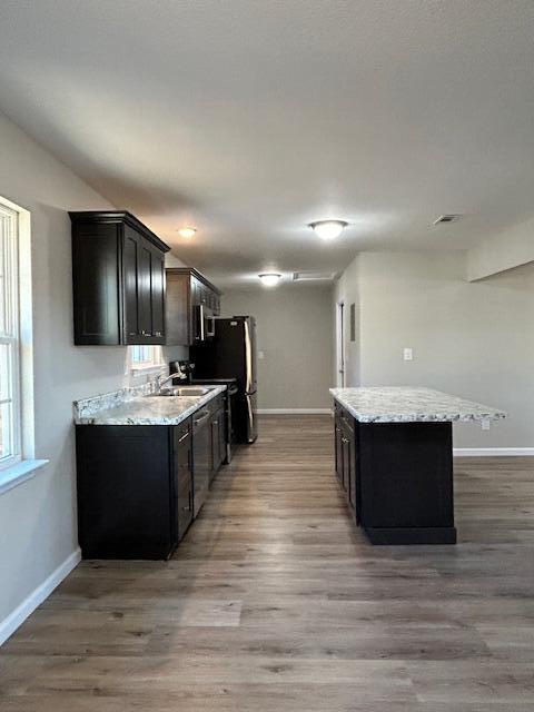332 Cannon Drive Laurel Hill, FL 32567 - Photo 13 of 36 a view of kitchen with kitchen island microwave and wooden floor