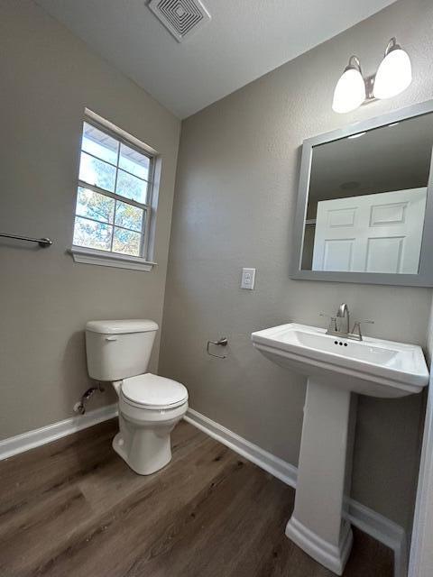 332 Cannon Drive Laurel Hill, FL 32567 - Photo 31 of 36 a bathroom with a toilet sink and mirror