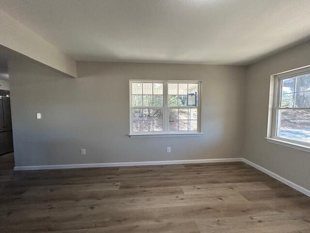 332 Cannon Drive Laurel Hill, FL 32567 - Photo 7 of 36 an empty room with wooden floor and windows