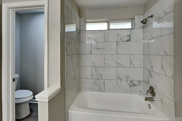 a bathroom with a bathtub and a toilet