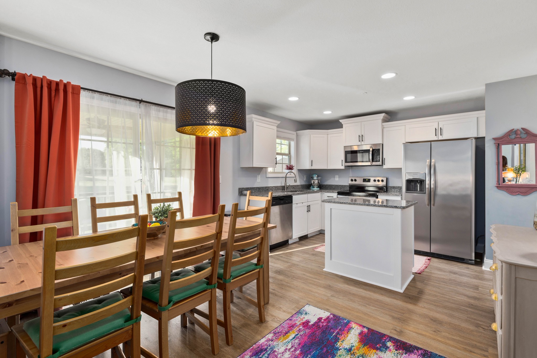 1646 Archer Drive Pleasant View, TN 37146 - Photo 8 of 33 a kitchen with stainless steel appliances kitchen island granite countertop a table chairs in it and wooden floors