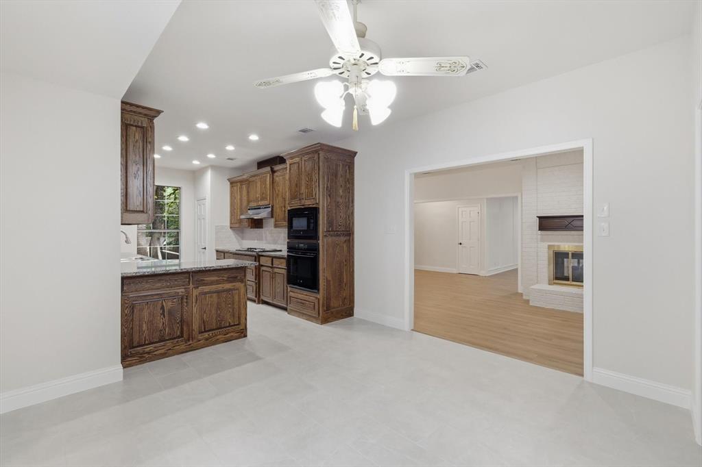 19 Timbergreen Circle Denton, TX 76205 - Photo 11 of 40 a open kitchen with a sink and a stove top oven