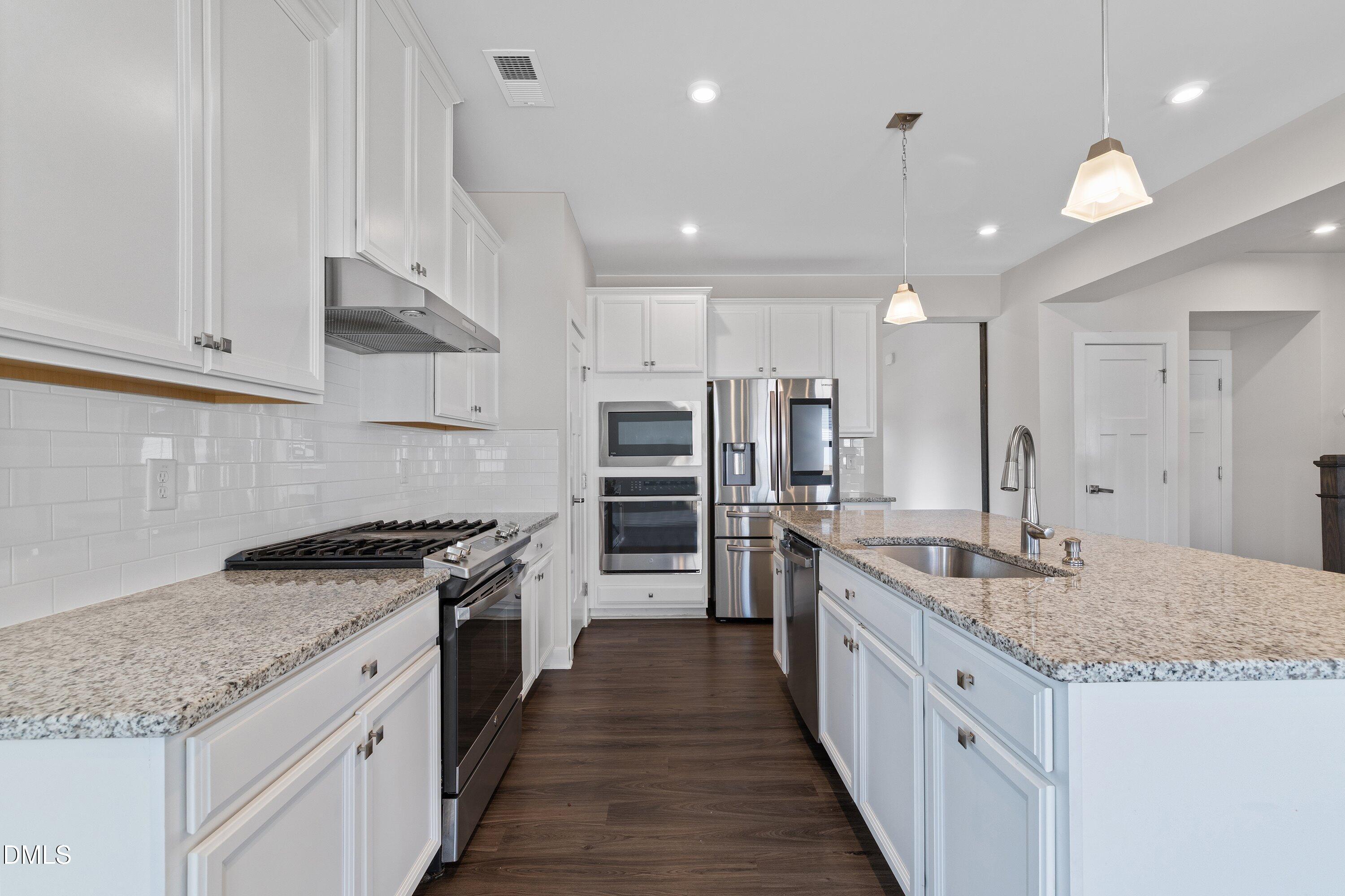 120 Misty Pike Drive Raleigh, NC 27603 - Photo 11 of 57 a large kitchen with stainless steel appliances granite countertop a sink stove and refrigerator