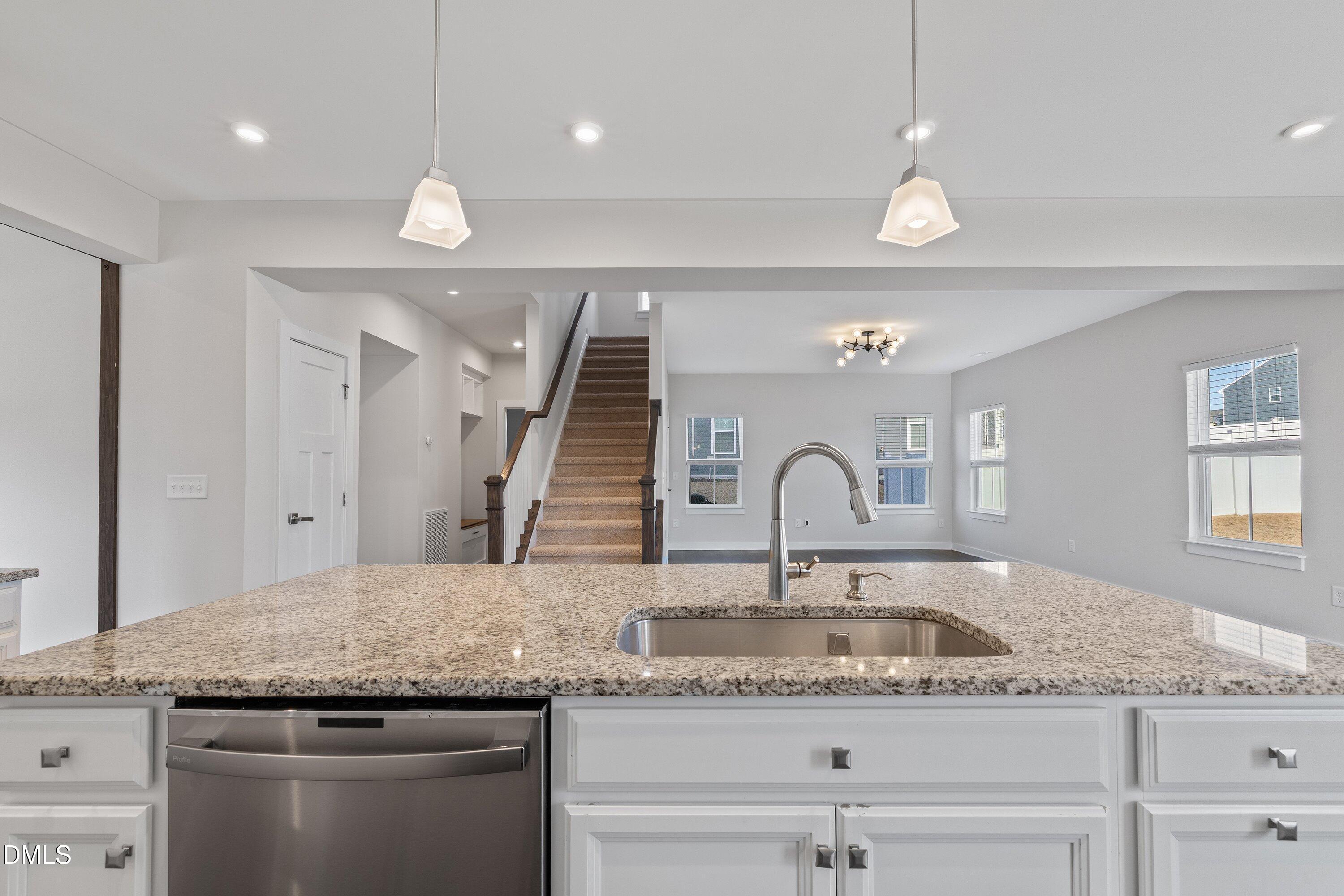 120 Misty Pike Drive Raleigh, NC 27603 - Photo 12 of 57 a kitchen with a granite countertop sink and a refrigerator