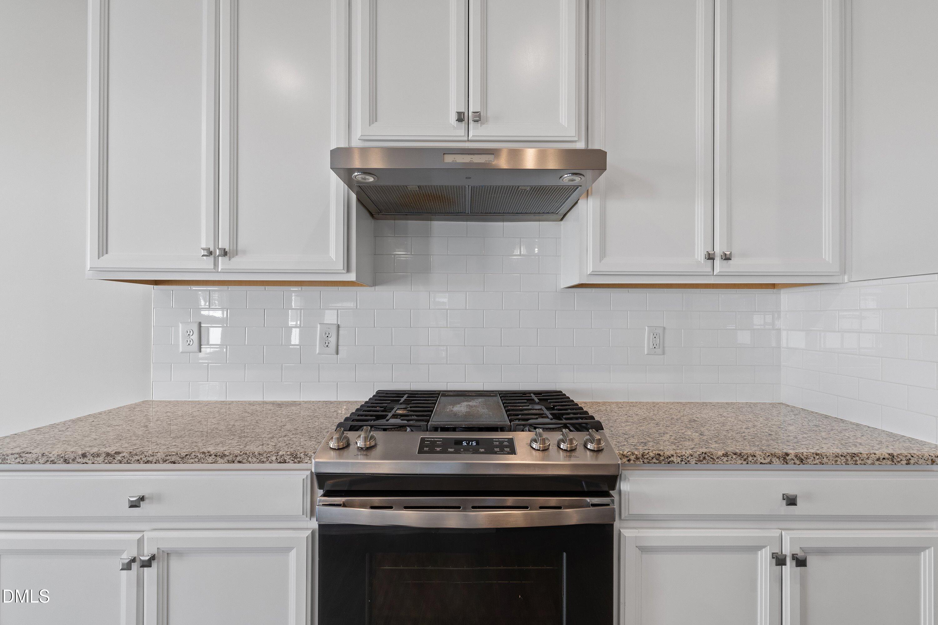 120 Misty Pike Drive Raleigh, NC 27603 - Photo 13 of 57 a stove top oven sitting inside of a kitchen