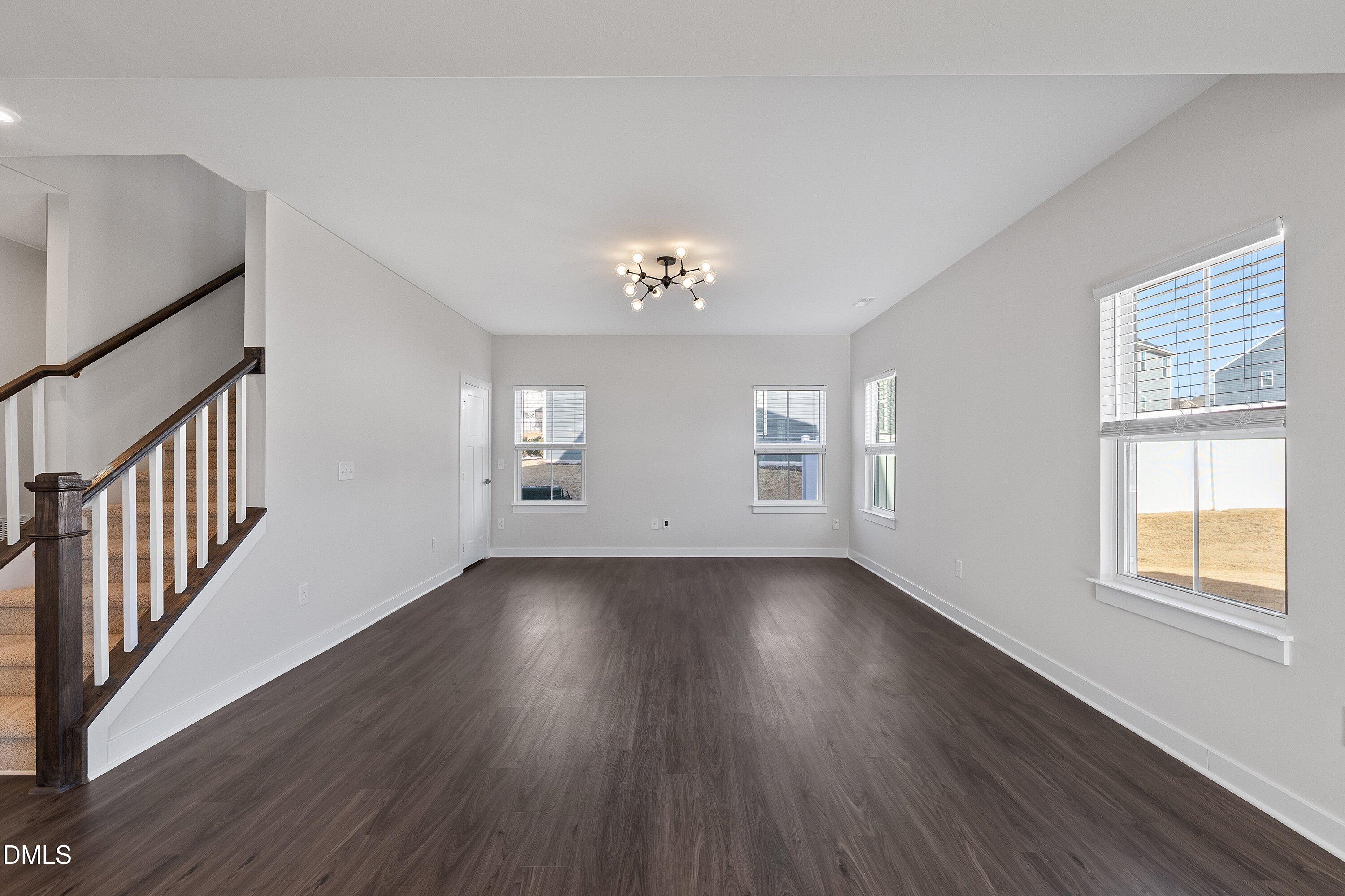 120 Misty Pike Drive Raleigh, NC 27603 - Photo 15 of 57 a view of an empty room with wooden floor and a window