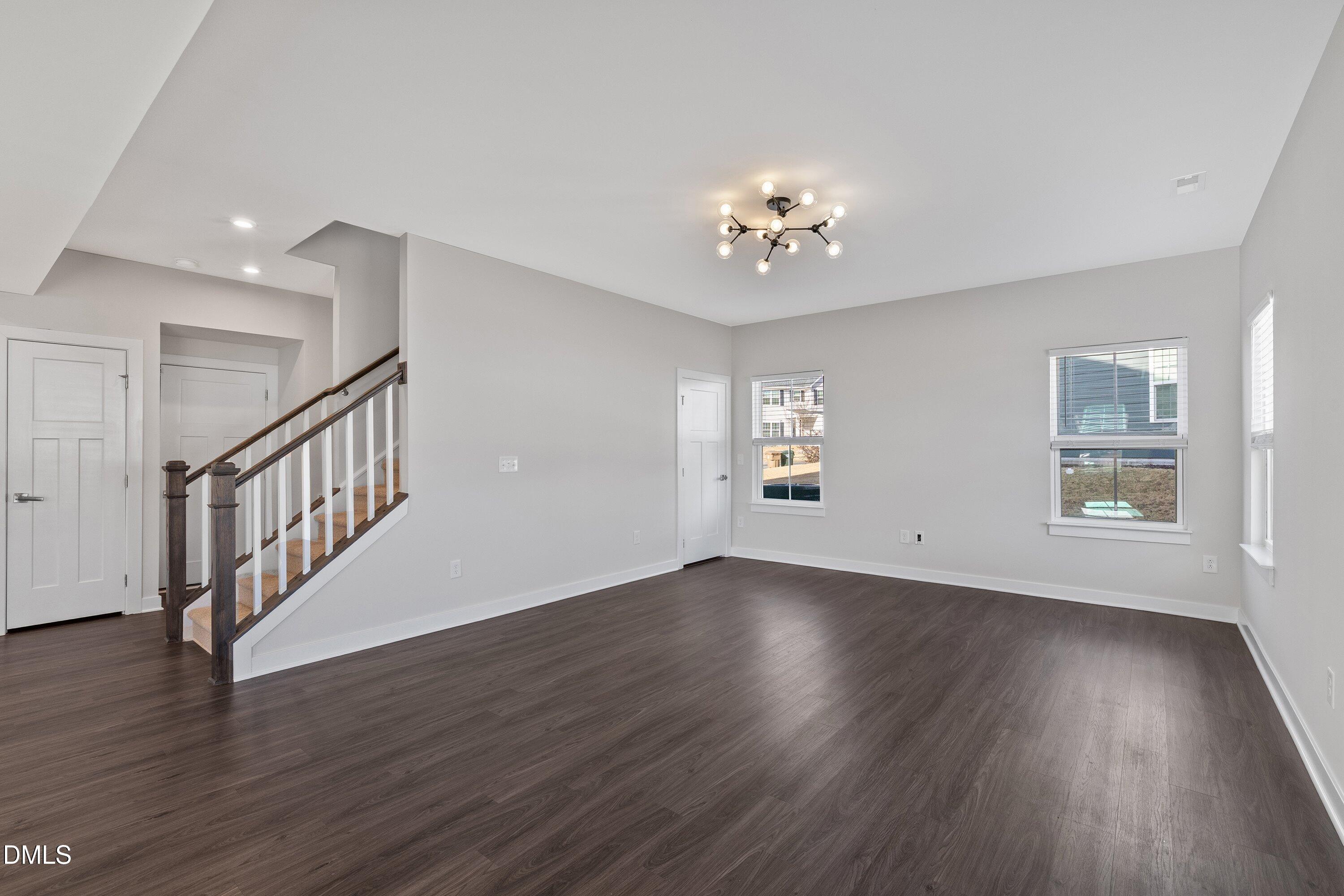 120 Misty Pike Drive Raleigh, NC 27603 - Photo 17 of 57 a view of an empty room with a window and wooden floor