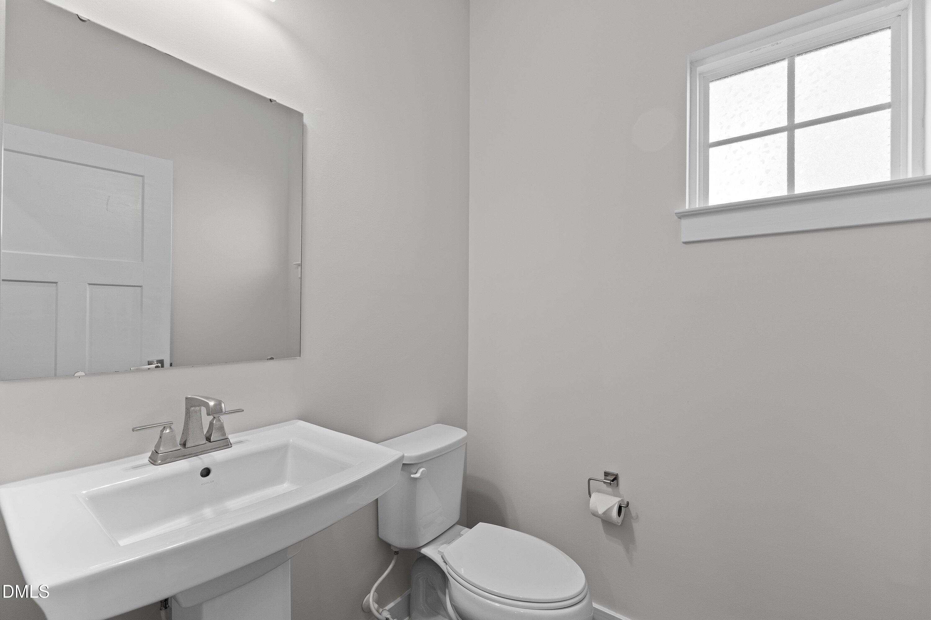 120 Misty Pike Drive Raleigh, NC 27603 - Photo 20 of 57 a bathroom with a sink mirror and toilet