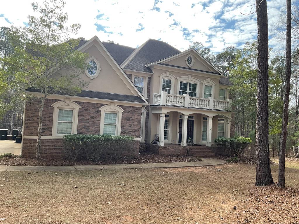 a front view of a house with garden