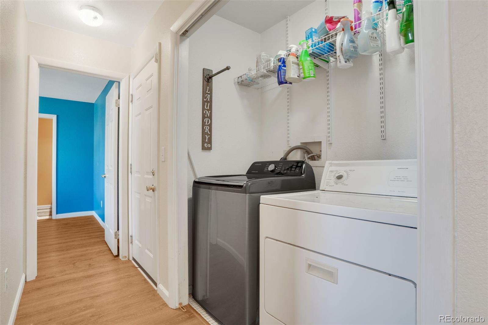 210 South Elm Street Bennett, CO 80102 - Photo 11 of 31 a view of storage and utility room with washer and dryer