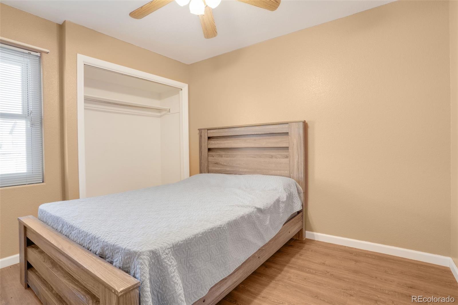 210 South Elm Street Bennett, CO 80102 - Photo 13 of 31 a bedroom with a bed and a dresser