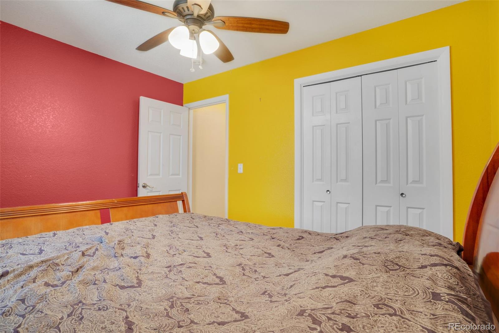 210 South Elm Street Bennett, CO 80102 - Photo 16 of 31 a bedroom with a bed and a chandelier