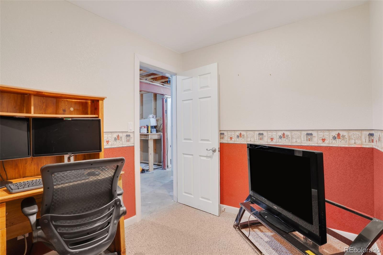 210 South Elm Street Bennett, CO 80102 - Photo 23 of 31 a room with furniture and a flat screen tv