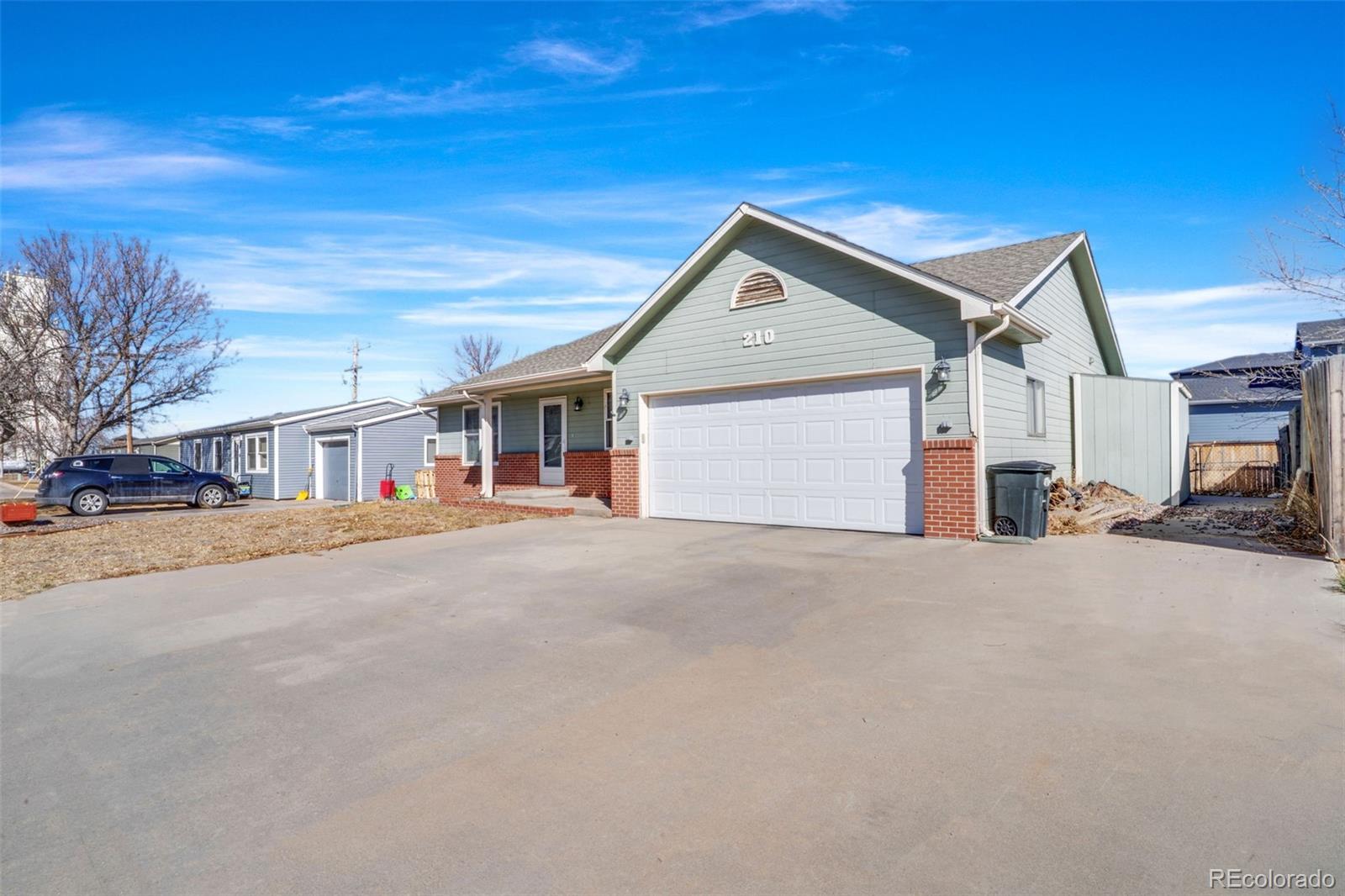 210 South Elm Street Bennett, CO 80102 - Photo 28 of 31 a view of a house with a street