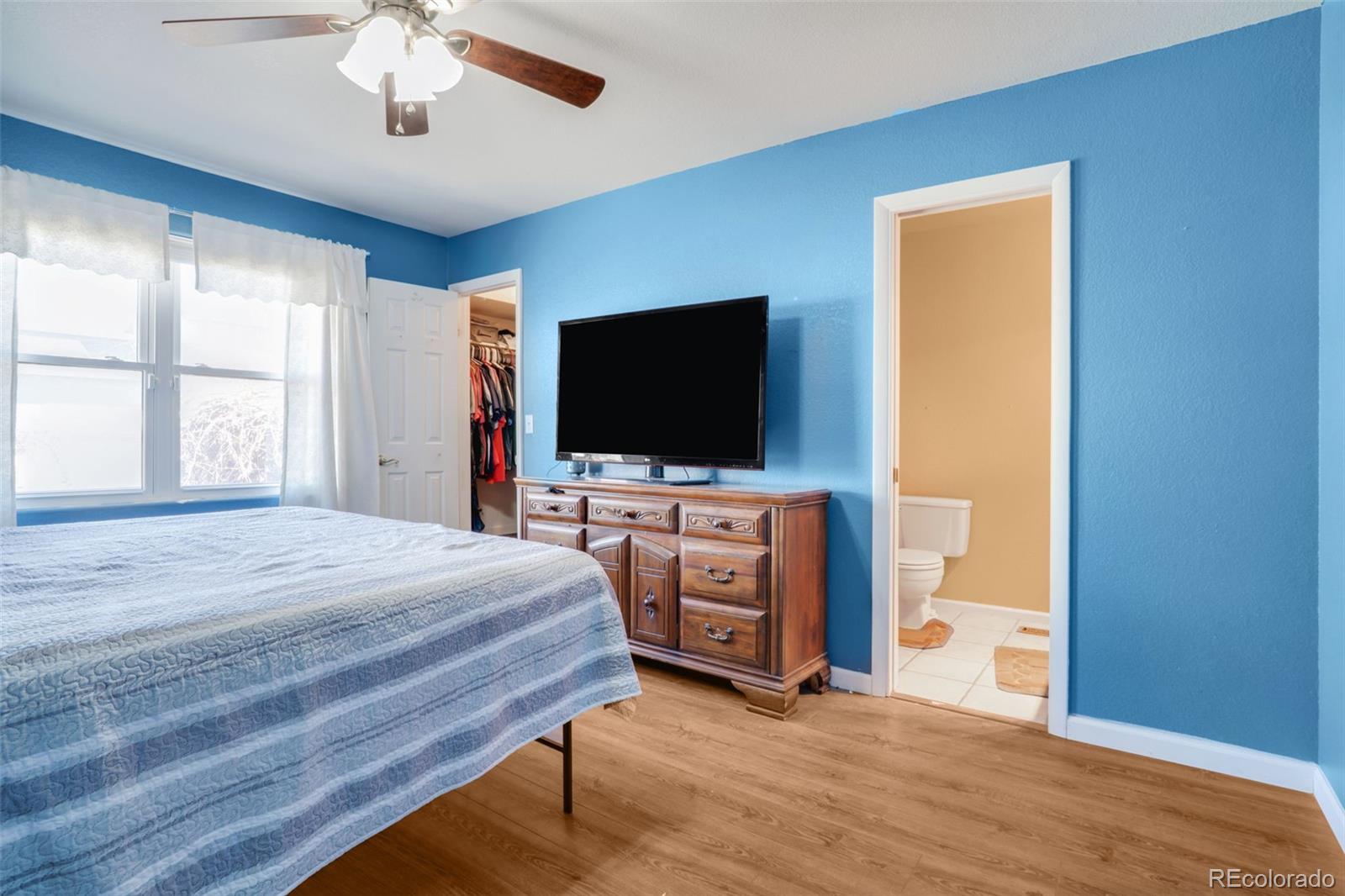 210 South Elm Street Bennett, CO 80102 - Photo 6 of 31 a bedroom with furniture and flat screen tv