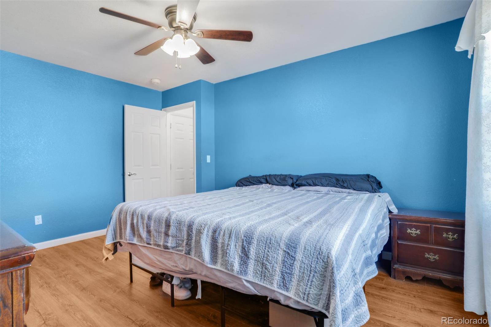 210 South Elm Street Bennett, CO 80102 - Photo 7 of 31 a bedroom with a bed and a closet