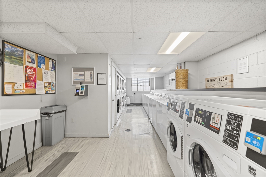 111 Perkins Street, Unit 261 Boston, MA 02130 - Photo 11 of 16 a view of a hallway with washer and dryer