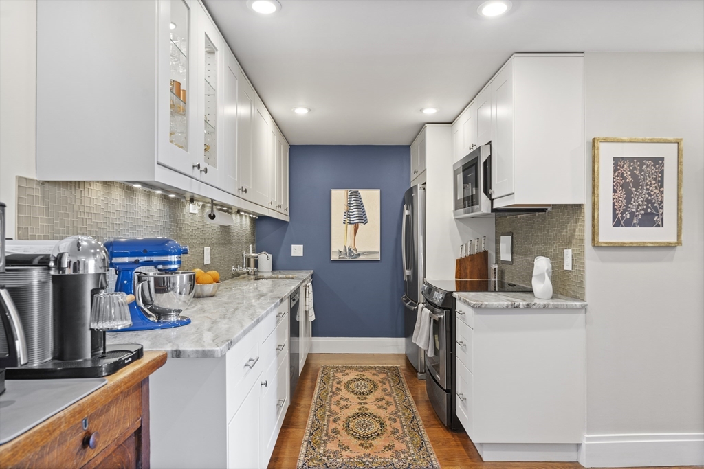 111 Perkins Street, Unit 261 Boston, MA 02130 - Photo 3 of 16 a kitchen with stainless steel appliances granite countertop a sink stove and refrigerator