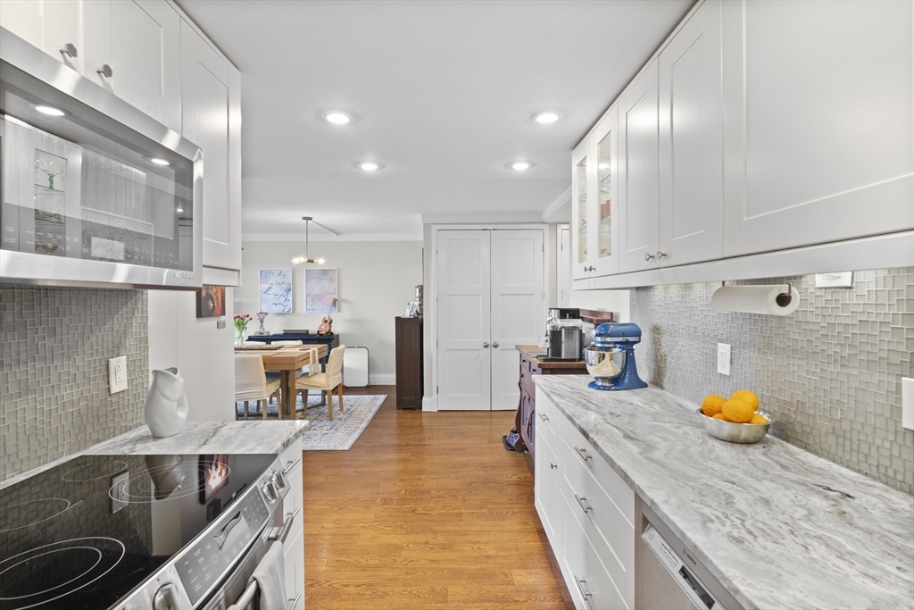 111 Perkins Street, Unit 261 Boston, MA 02130 - Photo 4 of 16 a kitchen with stainless steel appliances granite countertop a sink stove and refrigerator