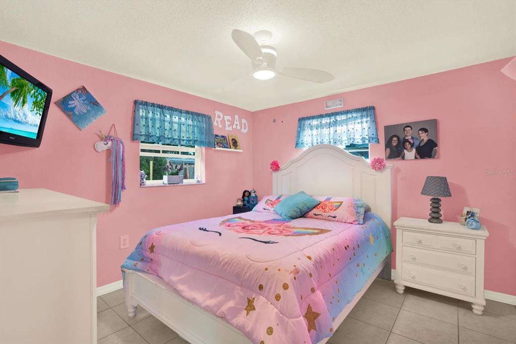 7415 Mayfield Drive Port Richey, FL 34668 - Photo 11 of 17 a bedroom with a bed a window and dresser