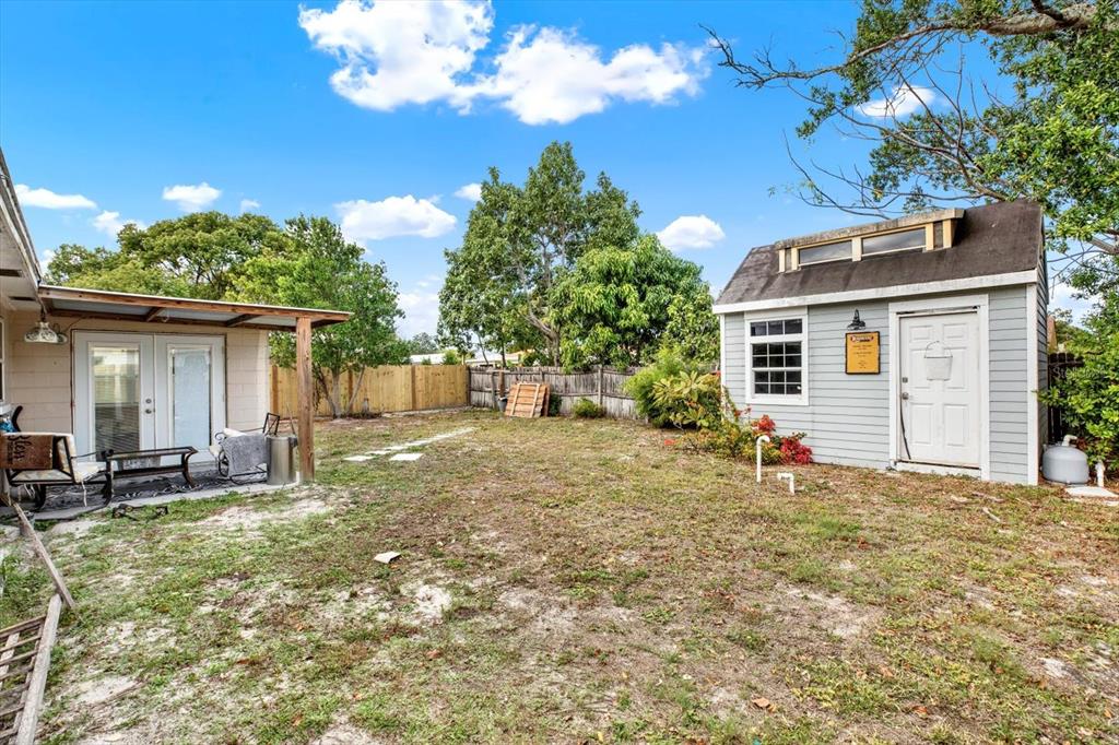 7415 Mayfield Drive Port Richey, FL 34668 - Photo 14 of 17 a backyard of a house with table and chairs