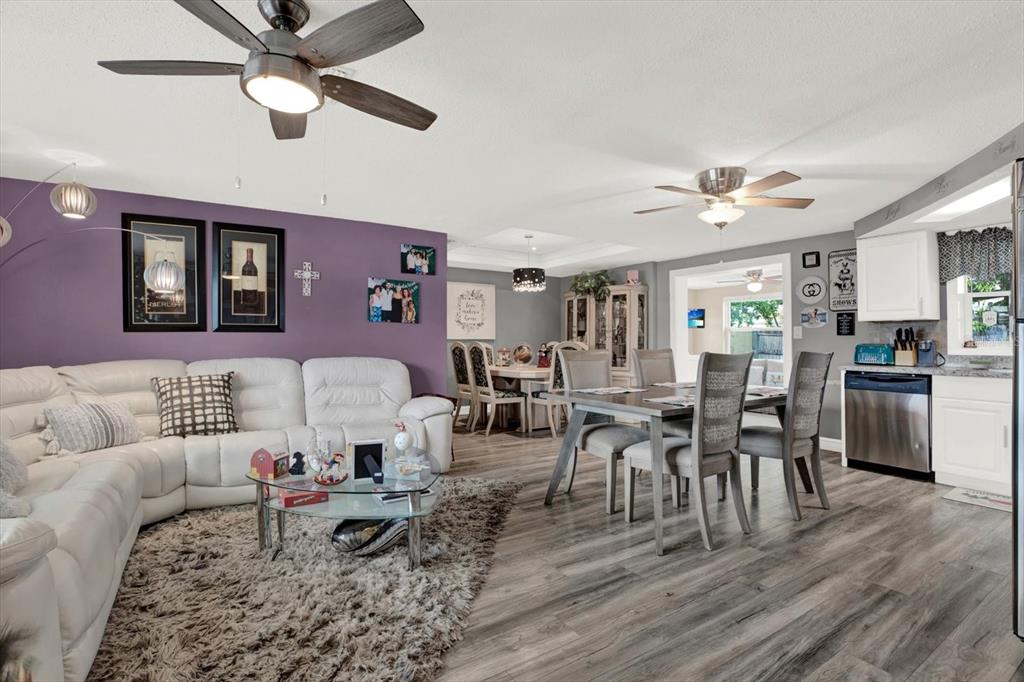 7415 Mayfield Drive Port Richey, FL 34668 - Photo 2 of 17 a living room with furniture kitchen view and a dining table