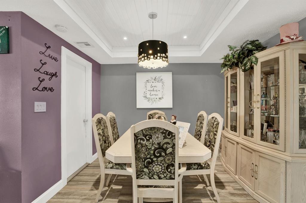 7415 Mayfield Drive Port Richey, FL 34668 - Photo 5 of 17 a view of a dining room with furniture and chandelier