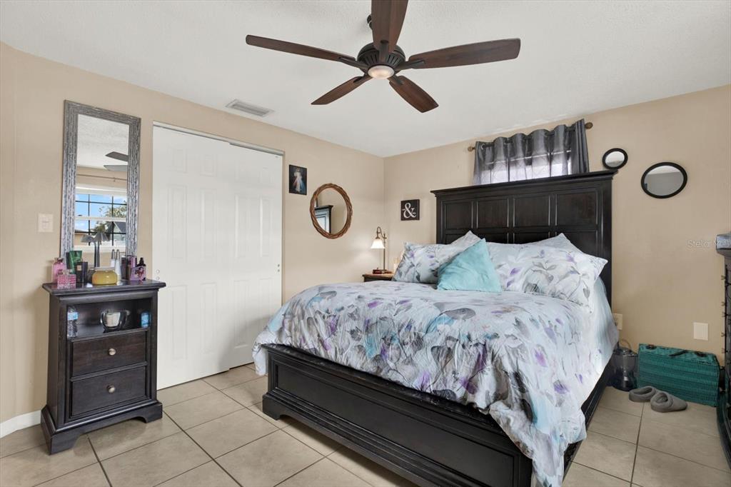 7415 Mayfield Drive Port Richey, FL 34668 - Photo 9 of 17 a bedroom with a bed and dresser