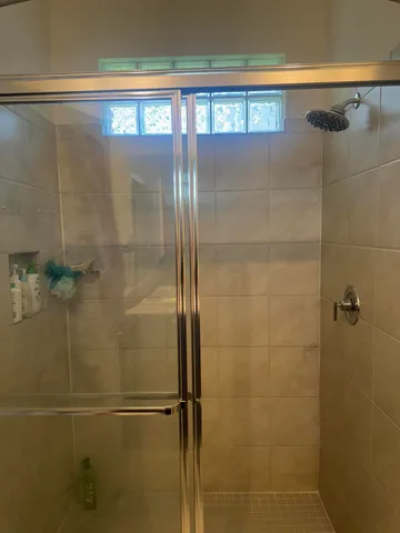 a bathroom with a glass shower door