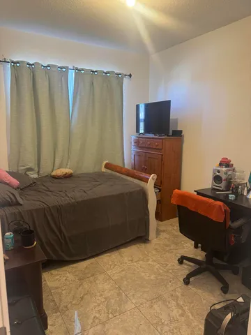 a bedroom with a bed and a chair