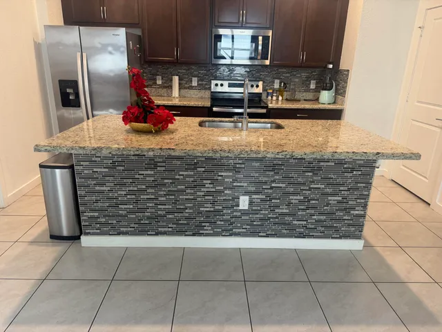 a kitchen with a wooden cabinet and a refrigerator