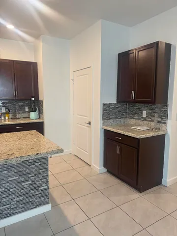 a bathroom with a granite countertop sink and a vanity