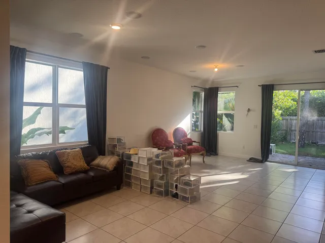 a living room with furniture a window and a chandelier