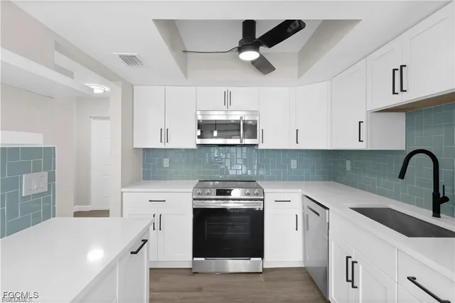 a kitchen with cabinets a sink and appliances