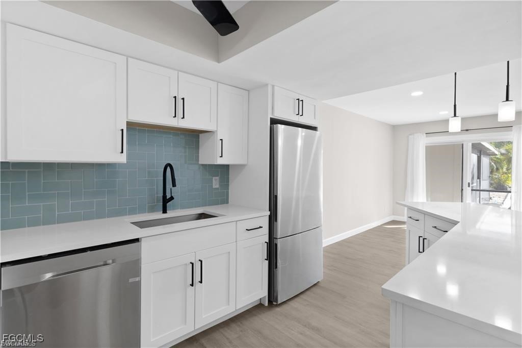 13446 Heald Lane, Unit 5B Fort Myers, FL 33908 - Photo 4 of 9 a kitchen with white cabinets and sink