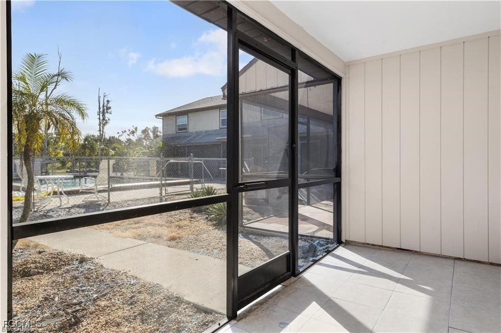 13446 Heald Lane, Unit 5B Fort Myers, FL 33908 - Photo 5 of 9 a view of a glass door with a yard
