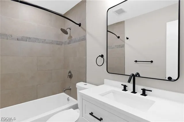 a bathroom with a sink a toilet and a bathtub