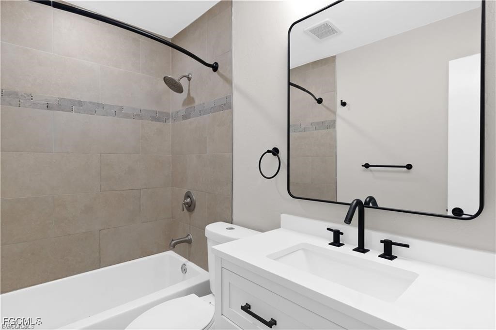 13446 Heald Lane, Unit 5B Fort Myers, FL 33908 - Photo 6 of 9 a bathroom with a sink a toilet and a bathtub