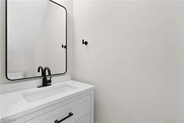 a bathroom with a sink and mirror