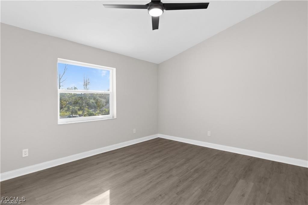 13446 Heald Lane, Unit 5B Fort Myers, FL 33908 - Photo 9 of 9 a view of an empty room with wooden floor and a window