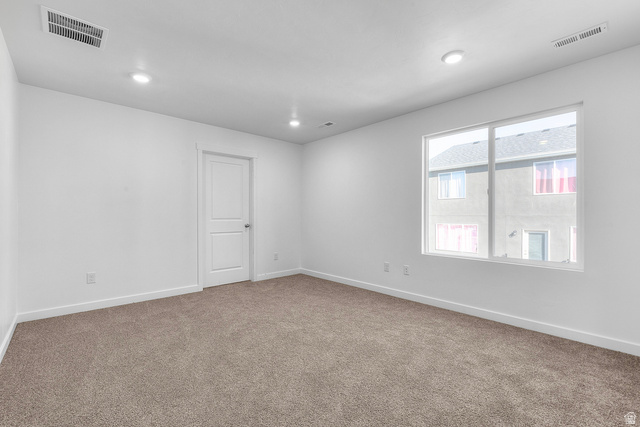 788 West 2840 South, Unit 2 Logan, UT 84321 - Photo 17 of 21 Spacious room featuring neutral carpeting, white walls, recessed lighting, and a large window