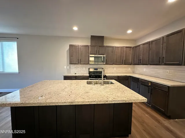 an empty room with windows and fireplace