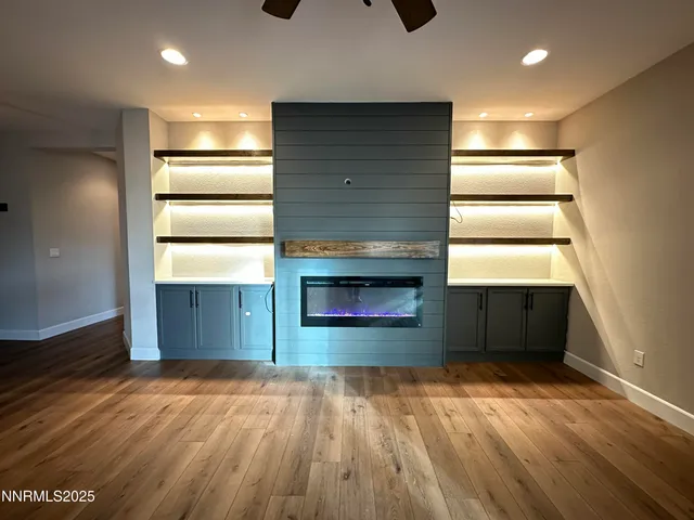 an empty room with a window and a ceiling fan