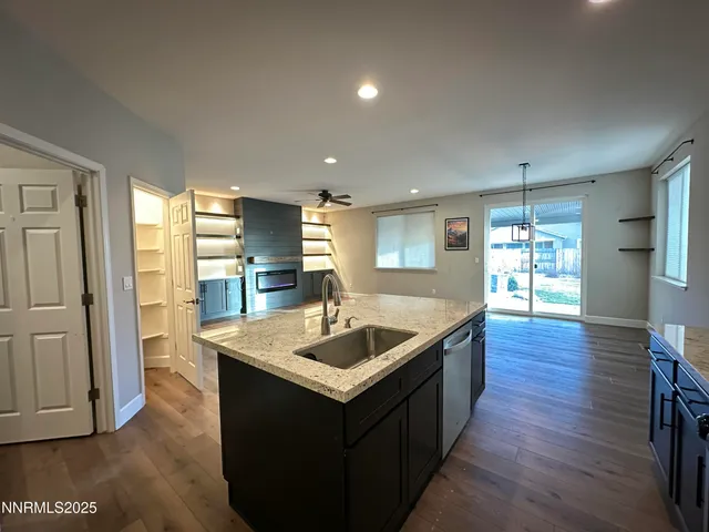 a view of an empty room with a ceiling fan and window