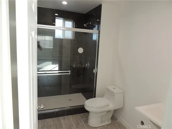 a bathroom with a toilet and a shower