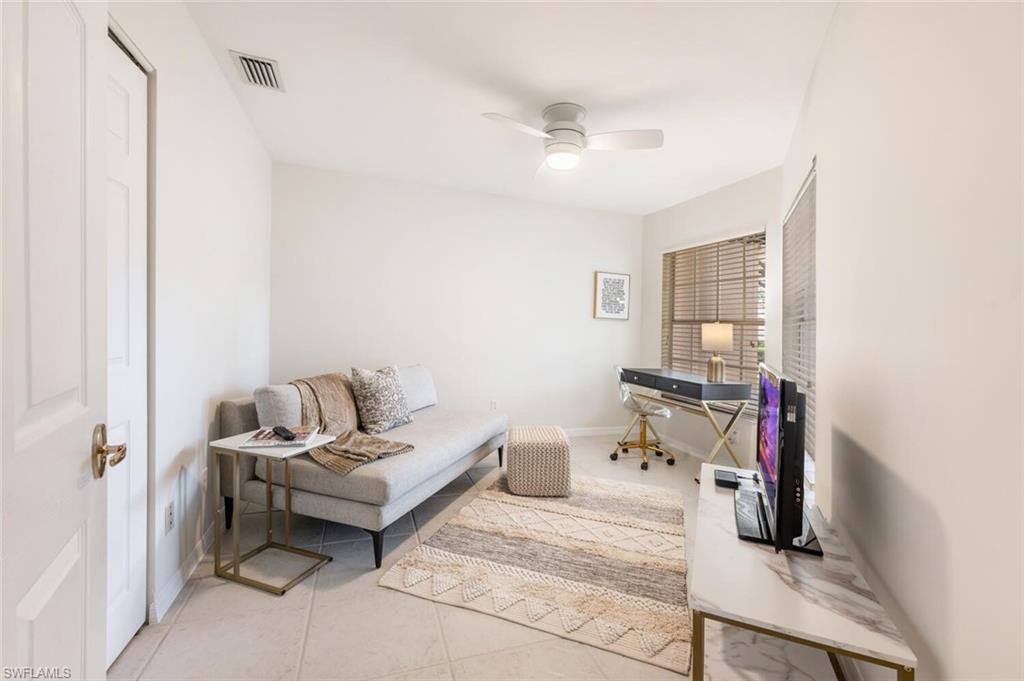 2835 Mizzen Way Naples, FL 34109 - Photo 13 of 46 a living room with furniture and a mirror